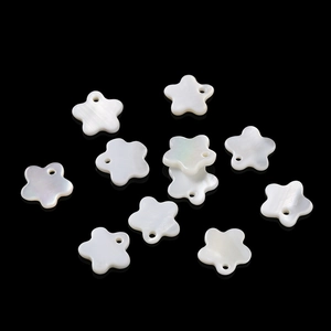 Close-up of white star-shaped mother of pearl shell beads with pre-drilled holes