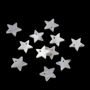 Macro view of natural white shell star beads with pre-drilled holes for DIY jewelry