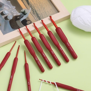 Detailed set of ergonomic red TPR crochet hooks with aluminum tips and soft handles