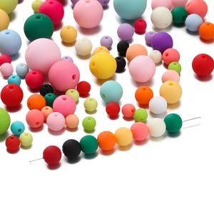 Macro detail of colorful 6mm acrylic matte beads on wire for DIY jewelry making