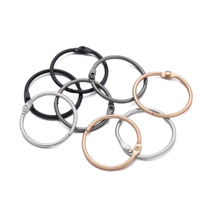 Close-up of assorted metal binder rings in silver, rose gold, black and gunmetal finishes