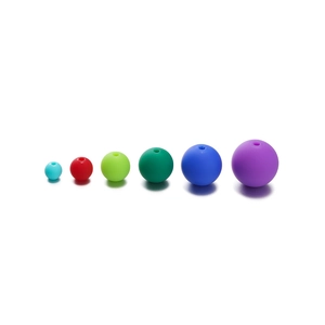 Macro detail of 6mm acrylic matte round beads in vibrant mixed colors for DIY jewelry