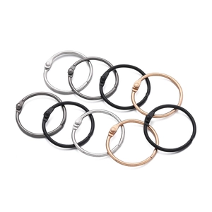 Detail showing colorful loose-leaf metal rings in silver, gunmetal, black, and rose gold