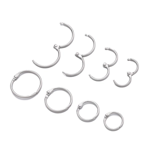 Detail of multi-size metal binder rings showing open and closed hinge mechanisms