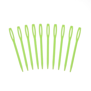 Macro view of 11 green large-eye plastic sewing needles for DIY knitting and crafts