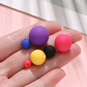 Macro shot of colorful matte acrylic beads for DIY jewelry making in various sizes