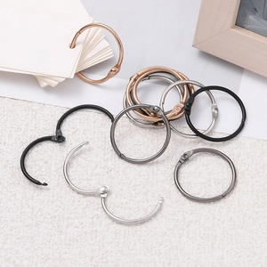 Assorted metallic binders in gold, silver, and black finishes for DIY keychains and journals