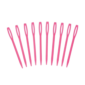 Close-up of ten rose red large-eye plastic sewing needles for DIY knitting and crafts