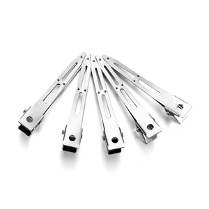 Close-up of five polished silver duckbill hair clips arranged in a fan shape on white background