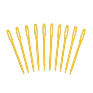 Macro shot of 10 yellow plastic sewing needles with large eyes for yarn knitting crafts