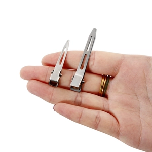 Silver metal duckbill hair clips for DIY hair accessories shown on hand for scale