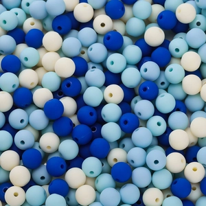 Macro shot of 6mm blue and white acrylic beads with a smooth matte paint texture for DIY crafts