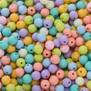 Macro view of assorted 6mm matte macaron acrylic beads with smooth central holes