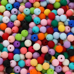 Macro shot of 6mm matte acrylic beads in mixed colors with a smooth finish for DIY jewelry