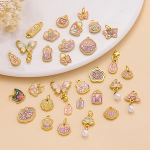 Detail of gold alloy enamel pendants with traditional butterfly and lotus charms