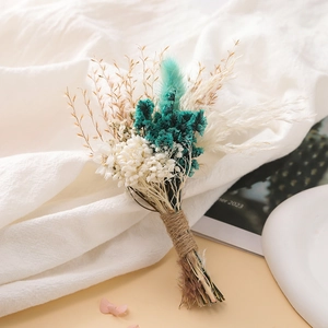 Detail of mini dried flower bouquet with blue blossoms and jute rope wrapping