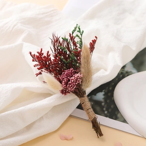 Detail of mini dried flower bouquet with red petals and natural twine handle for DIY decor