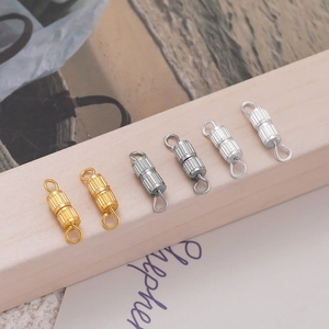 Macro detail of ribbed metal screw clasps for DIY jewelry making in gold and silver