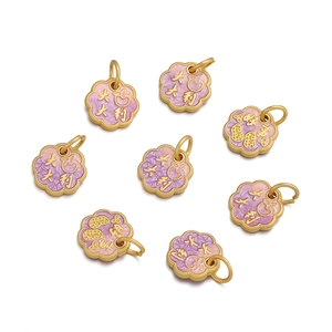 Macro view of flower-shaped enamel pendants with purple gradient and lucky symbols