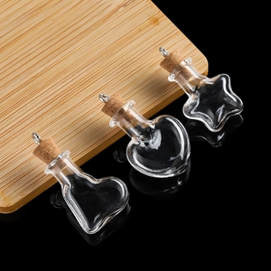 Macro detail of various mini heart and star glass bottles with natural cork stoppers