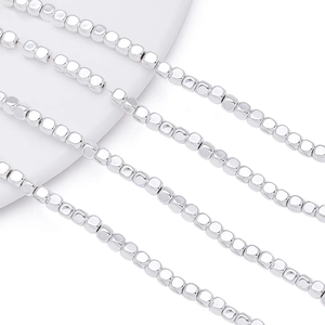 Macro detail of polished 2-4mm silver hematite square spacer beads for DIY jewelry making