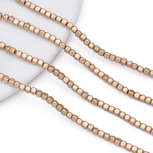 Macro detail of matte gold square cube beads for DIY jewelry making and bead strings