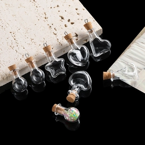Detailed view of various mini DIY glass bottles with cork stoppers and metal hooks