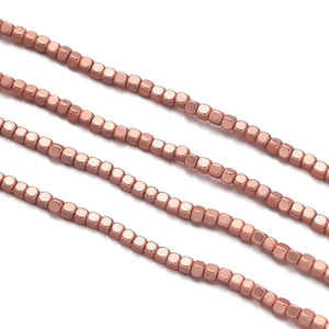 Macro shot of 2-4mm rose gold hematite cube beads for DIY necklace jewelry making