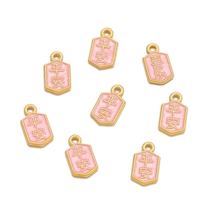 Detailed macro view of pink enamel charms with golden Peace and Joy Chinese characters