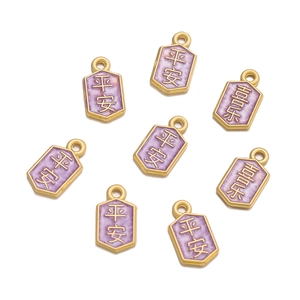 Macro shot of 8 purple enamel pendants with Chinese characters for DIY jewelry making