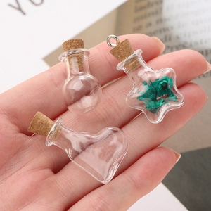 Miniature clear glass wishing bottles in heart, star and round shapes with cork stoppers
