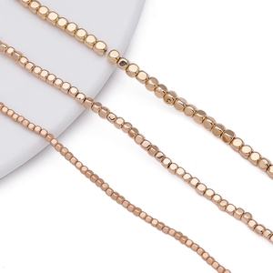 Macro detail of 18K rose gold plated hematite cube spacer beads for DIY jewelry making