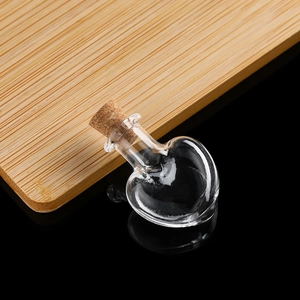 Macro detail of heart shaped mini glass wishing bottle with a natural cork stopper