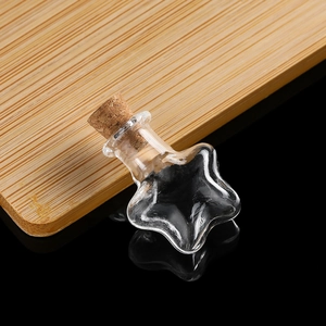 Macro detail of mini star-shaped transparent glass bottle with cork stopper
