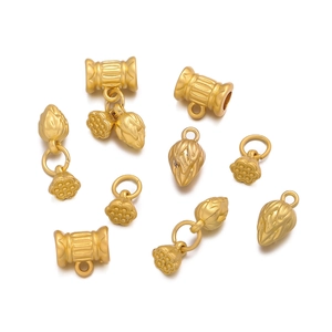 Detailed macro view of matte gold lotus seed head and botanical charms for DIY jewelry