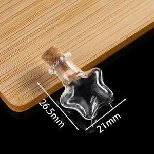 Detail view of mini star-shaped glass bottle with cork showing 26.5mm height dimensions