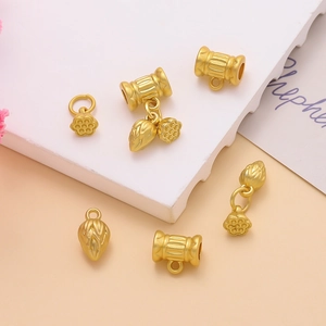 Detail of matte gold alloy flower charms and beads for DIY jewelry making