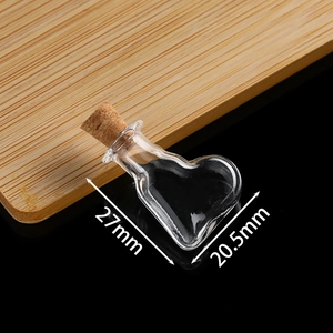 Macro view of mini heart-shaped glass bottle with dimensions 27mm height and 20.5mm width
