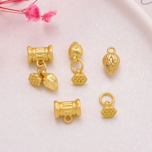 Detail of matte gold lotus pendants and beads for DIY jewelry making on pink background