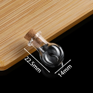 Macro shot of mini clear glass wish bottle with cork stopper, measuring 22.5mm by 14mm