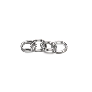 Close-up of four polished silver metal jump rings for DIY jewelry and keychain assembly