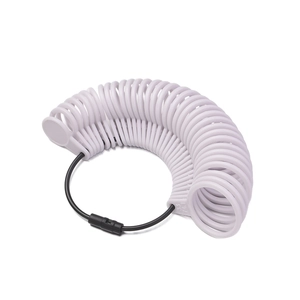 Close-up of white plastic ring sizer set with size markings on a black flexible loop