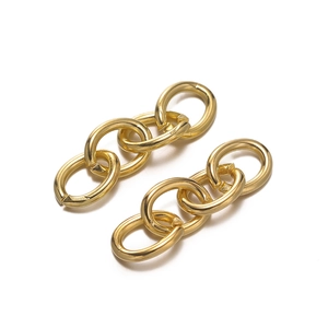 Close-up of three interlocking polished gold oval metal links for DIY jewelry crafting
