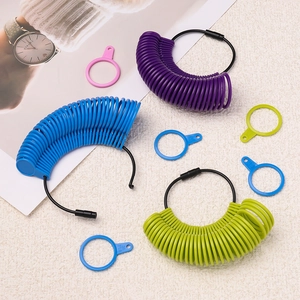 Plastic ring sizer measurement tool kit with multi-color rings on textured background