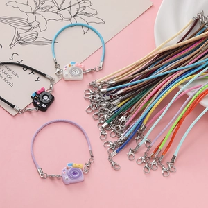 Macro shot of colorful 2mm waxed cord camera pendants with alloy lobster clasps