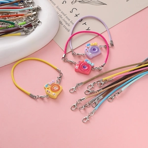 Close-up of colorful 2mm wax cords with metal lobster clasps and cute camera charms