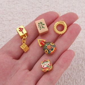 Macro detail of Chinese tradition Mahjong charms with gold finish and colorful enamel