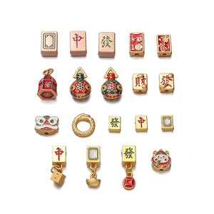 Macro view of Chinese red enamel Mahjong and lucky charm pendants for DIY jewelry