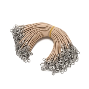 Detail of beige 2mm braided wax cords featuring silver lobster clasps for DIY jewelry making