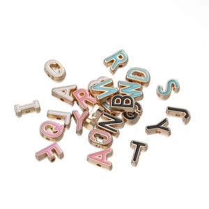 Macro shot of 10mm colorful enamel alphabet beads with gold-plated alloy finish for DIY